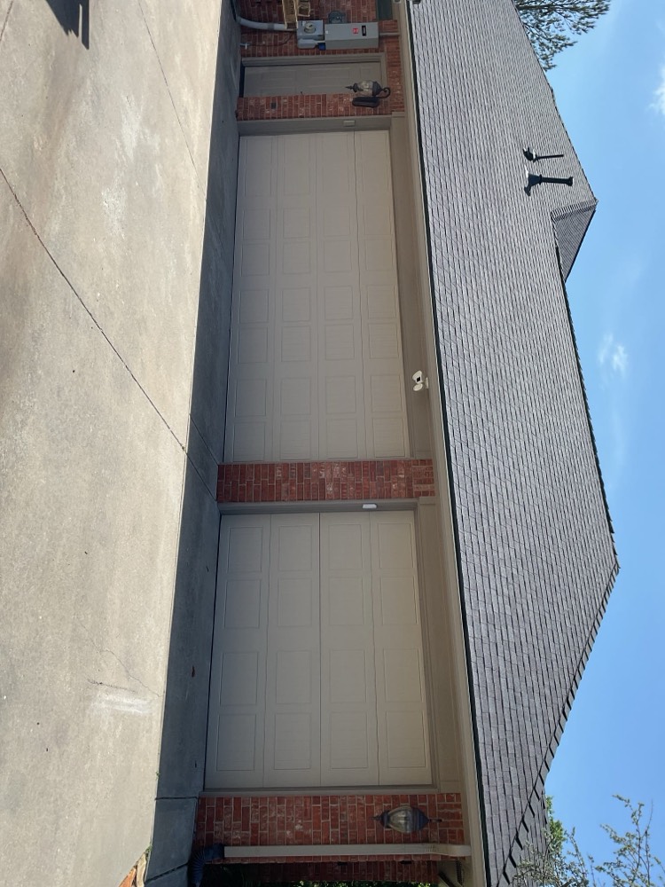 Newly installed gray garage doors on residential home