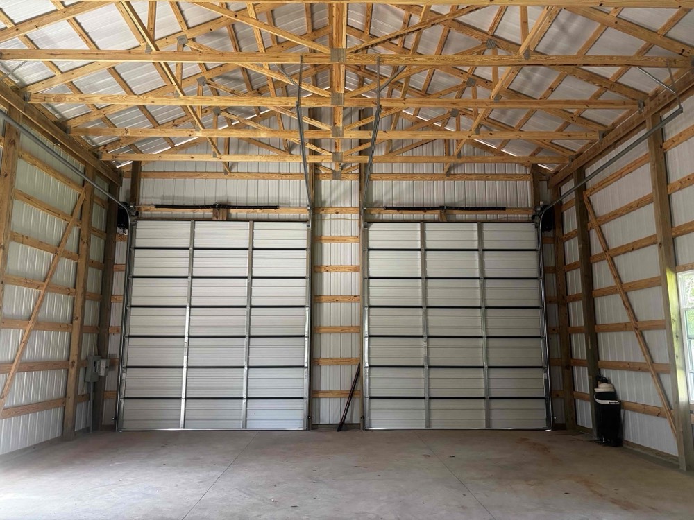 Interior view of two installed garage doors in completed metal building structure