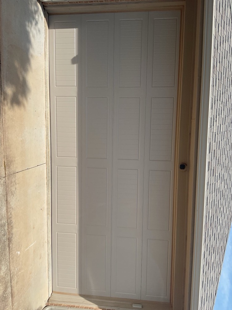Installed garage door with multi-panel design in neutral tone