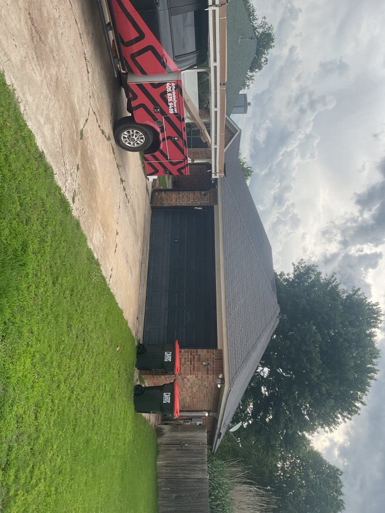 Completed black garage door installation on residential property