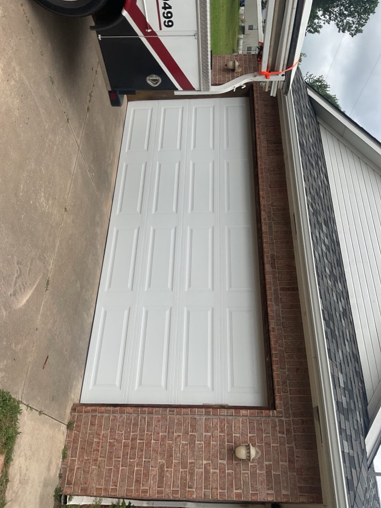 Finished white sectional garage door installation exterior view