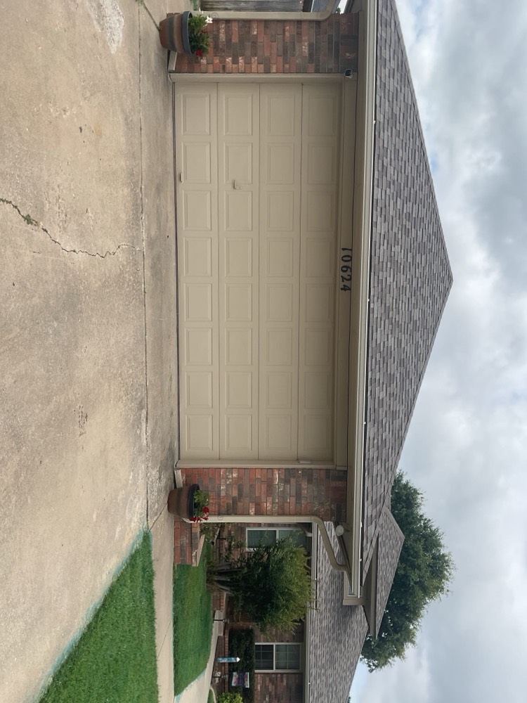 Completed white garage door installation on residence