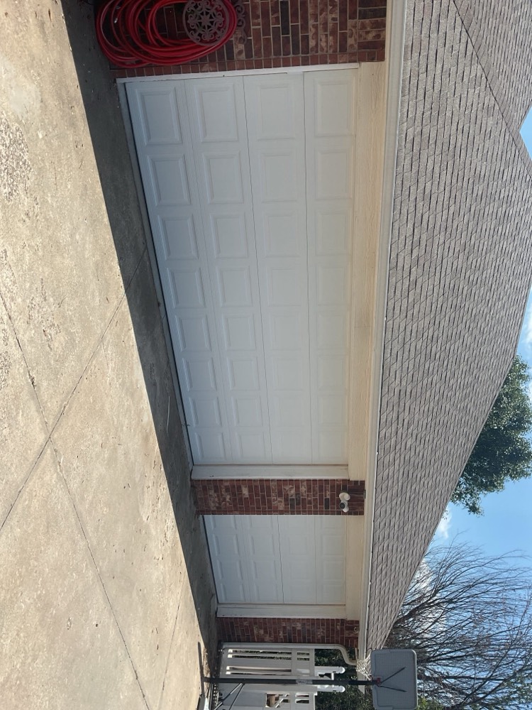 Two-car white garage door with nine-panel raised design installed