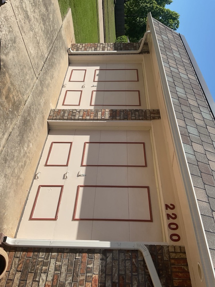 Installed two-car garage door with burgundy trim and window panels on home in Norman, OK.