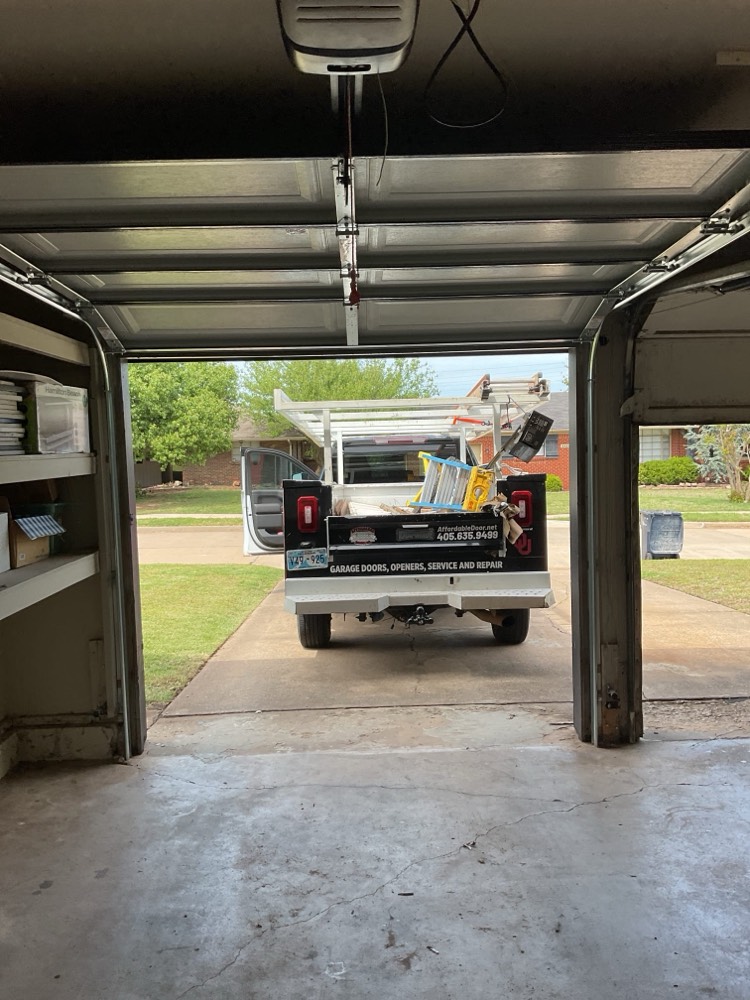 Interior view of installed garage door with service truck outside