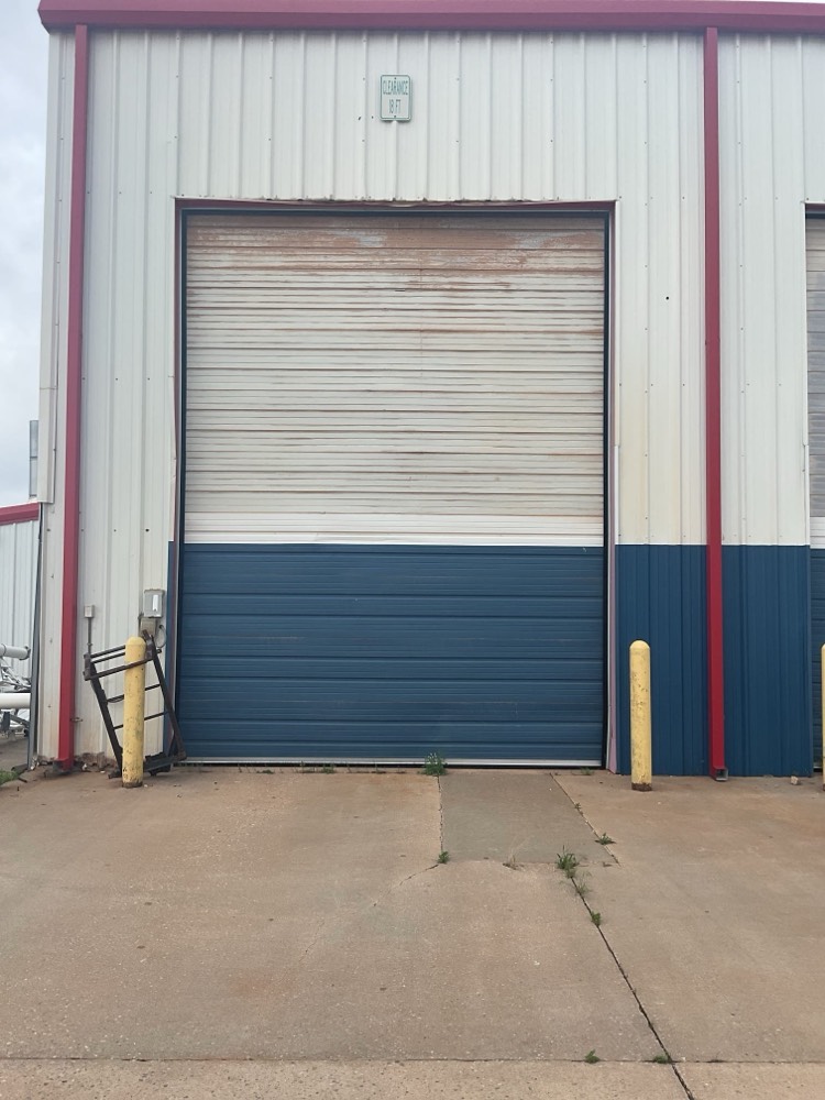 Two-tone garage door installation with white and blue panels
