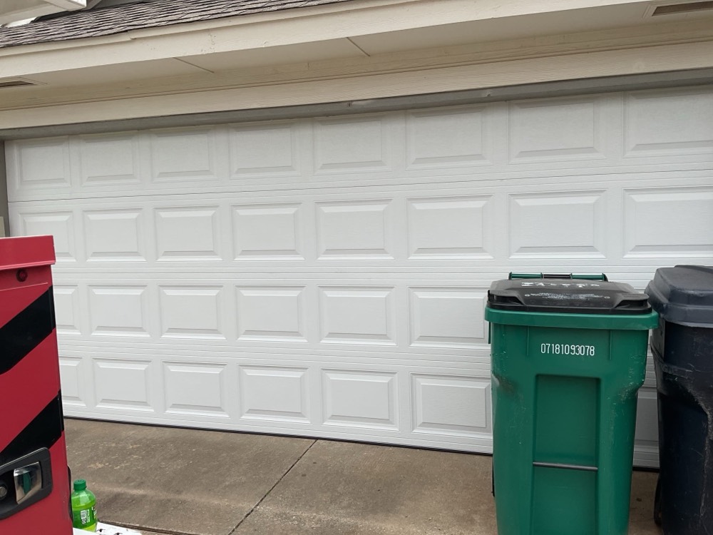 New white garage door installed on residential home