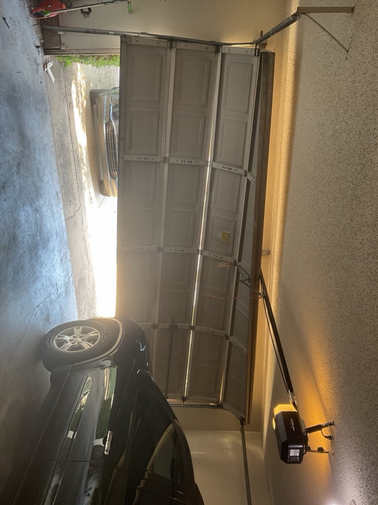 New garage door installed in garage opening.