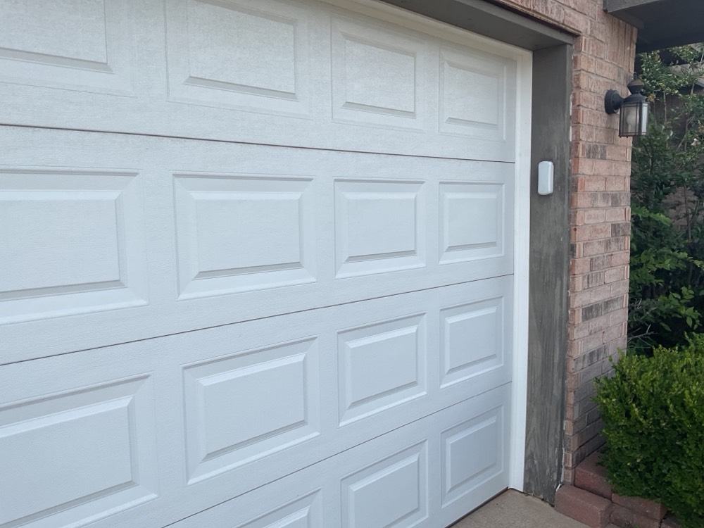 White garage door installation on brick home in Oklahoma City