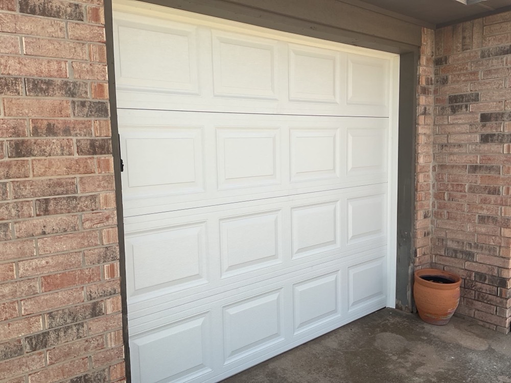 White paneled garage door installed on brick home in Oklahoma City