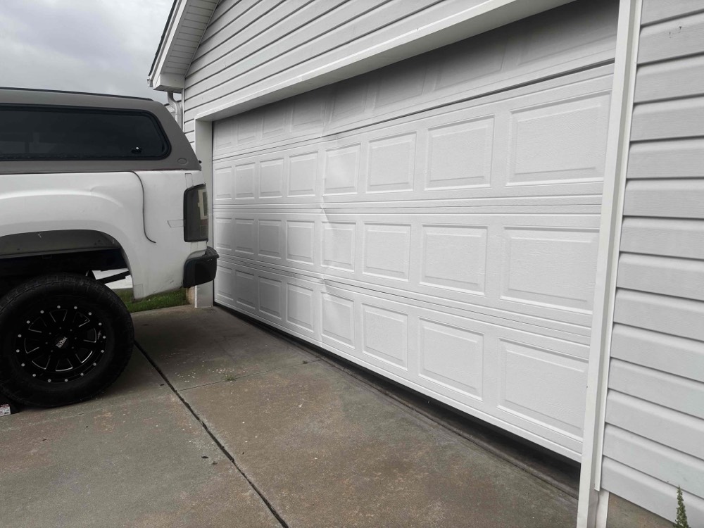 White garage door installation showing finished door in closed position