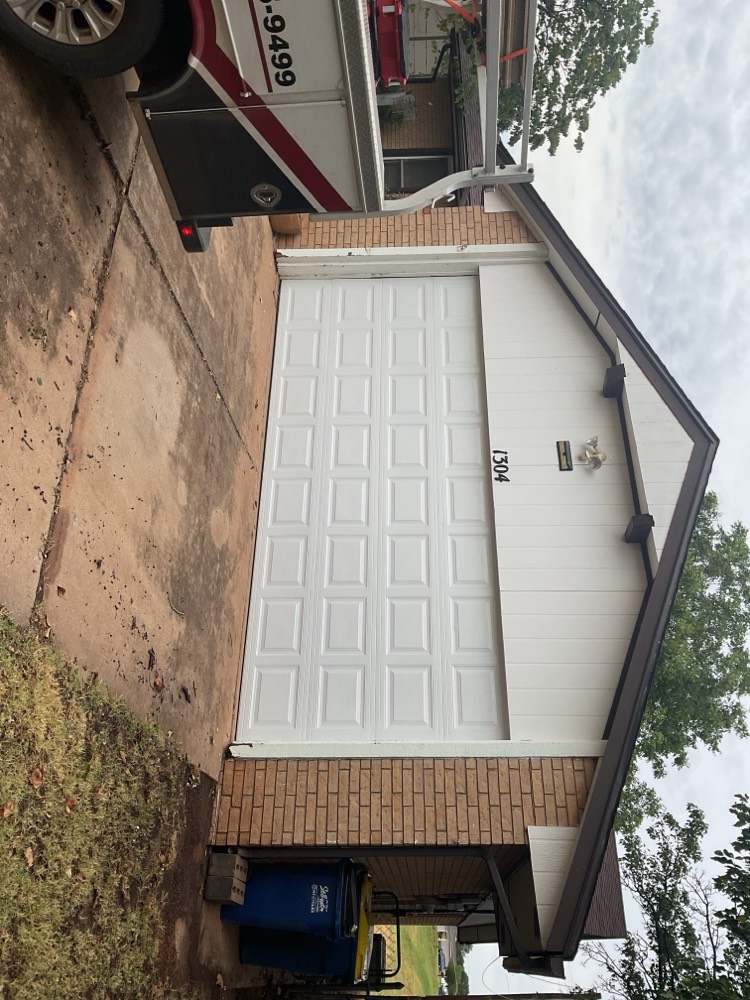 White raised-panel garage door installed on home in Stillwater