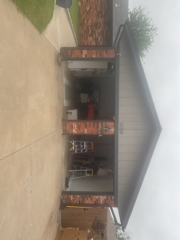 New garage door installation at brick home entrance in Yukon, OK