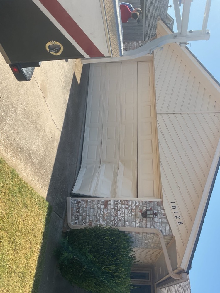 Finished garage door installation showing panel work and hardware