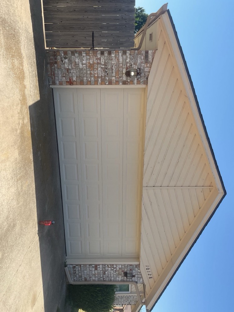 Newly installed two-panel garage door with finished hardware