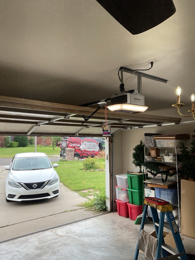 Installed garage door opener motor and track system