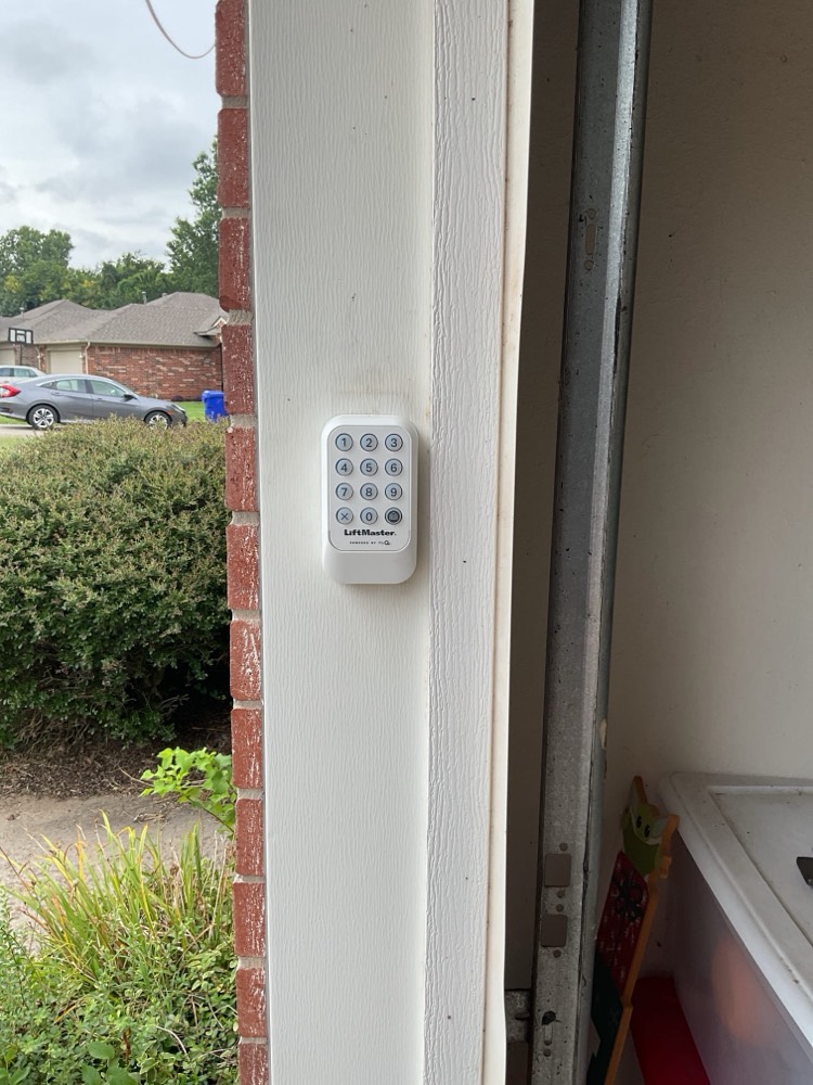 White LiftMaster wireless keypad mounted on garage door frame