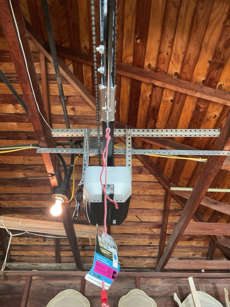 Installed garage door opener motor, rail, and chain system
