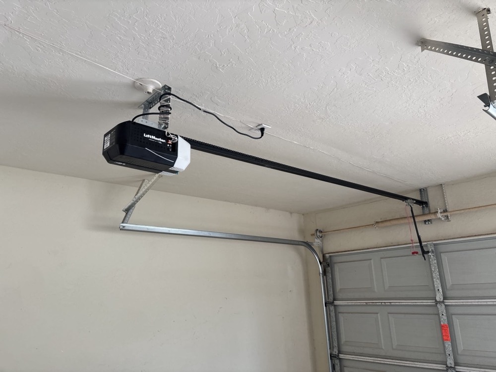 LiftMaster garage door opener installed on ceiling with metal support brackets.