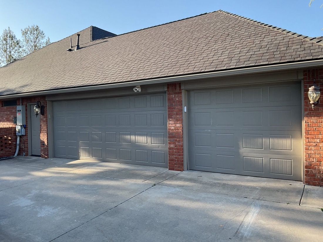 Installed gray garage doors on home exterior