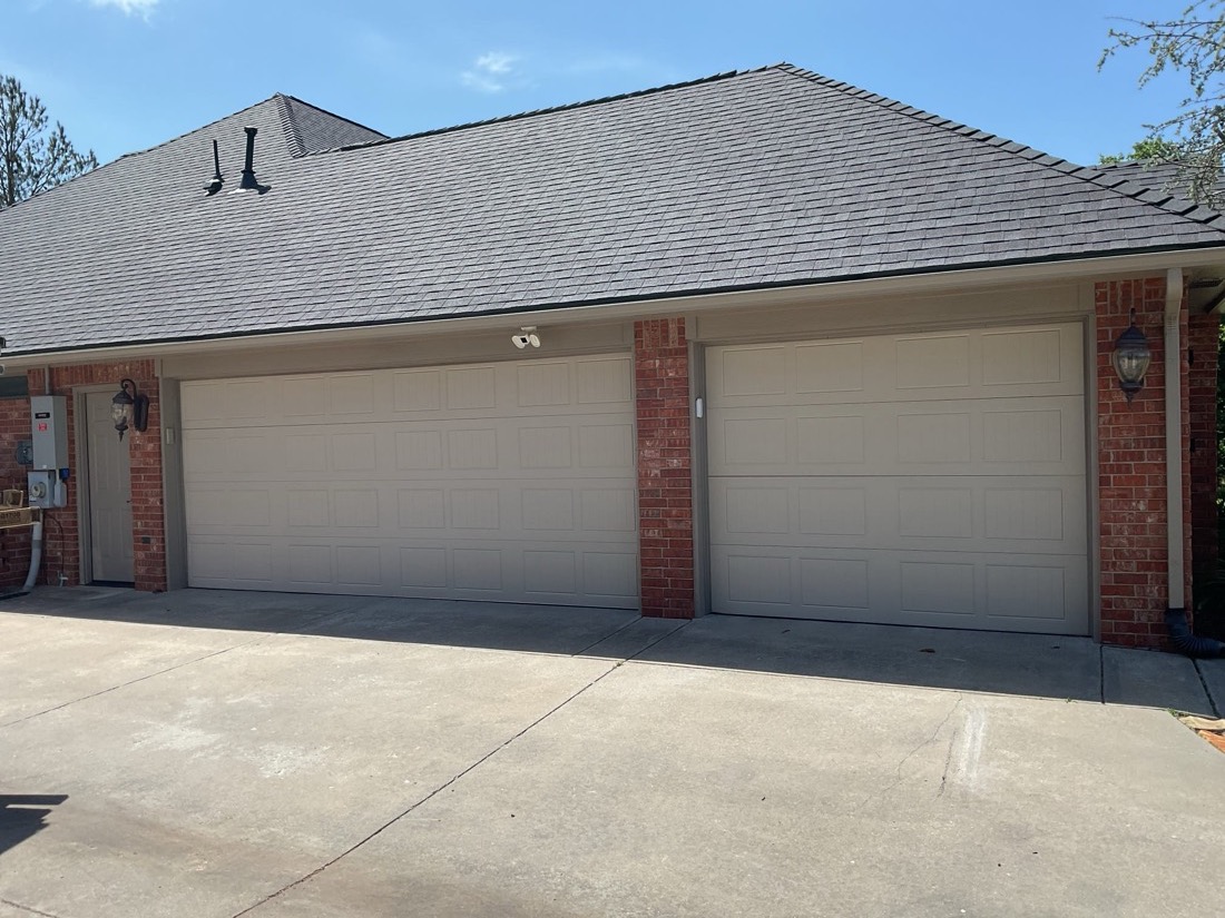 Newly installed gray garage doors on residential home