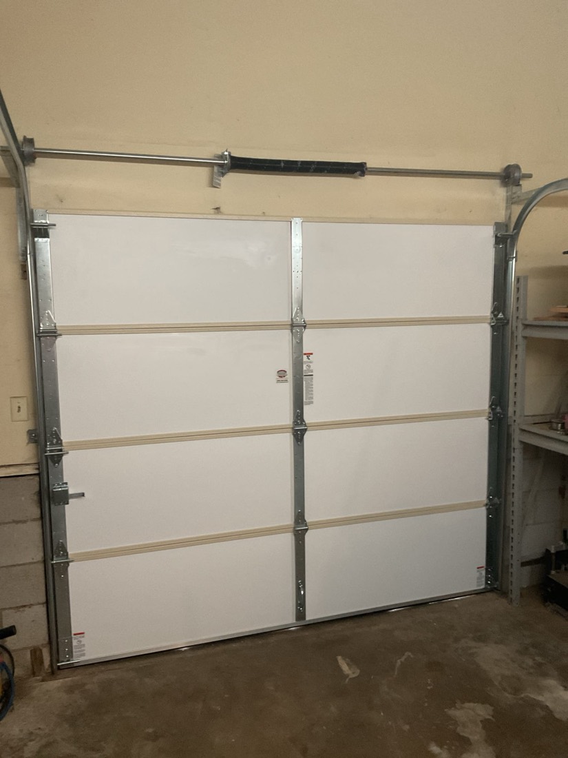 White two-car garage door with horizontal bracing and tracks.