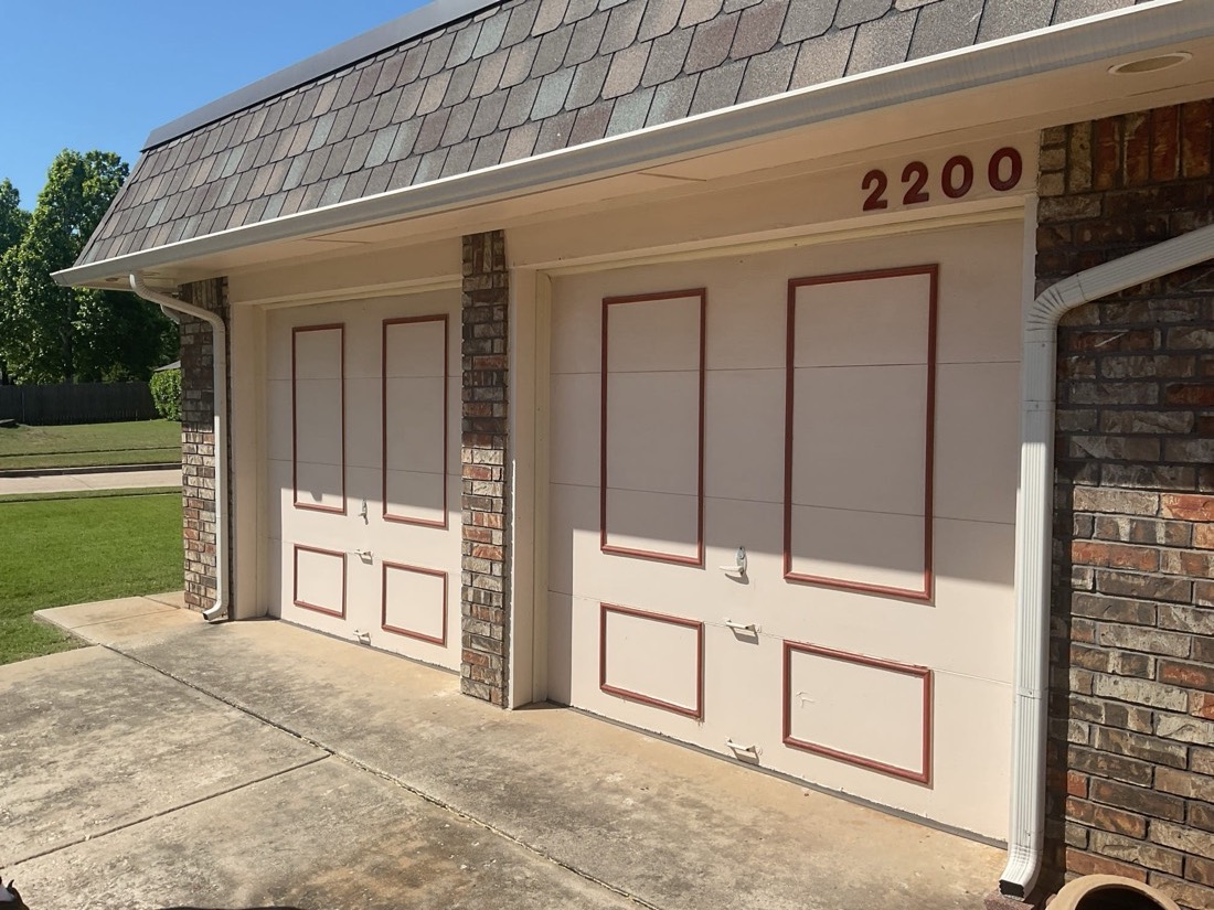 Installed two-car garage door with burgundy trim and window panels on home in Norman, OK.