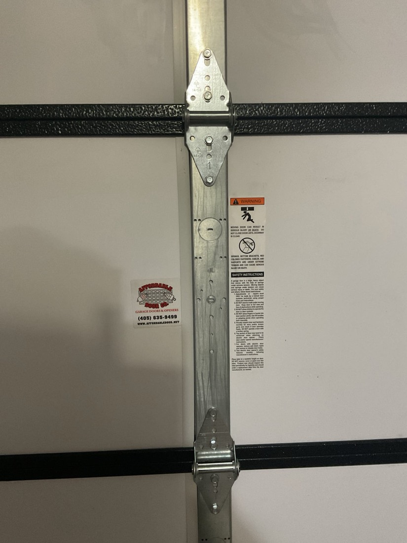 Garage door vertical track with center support bracket and hardware.