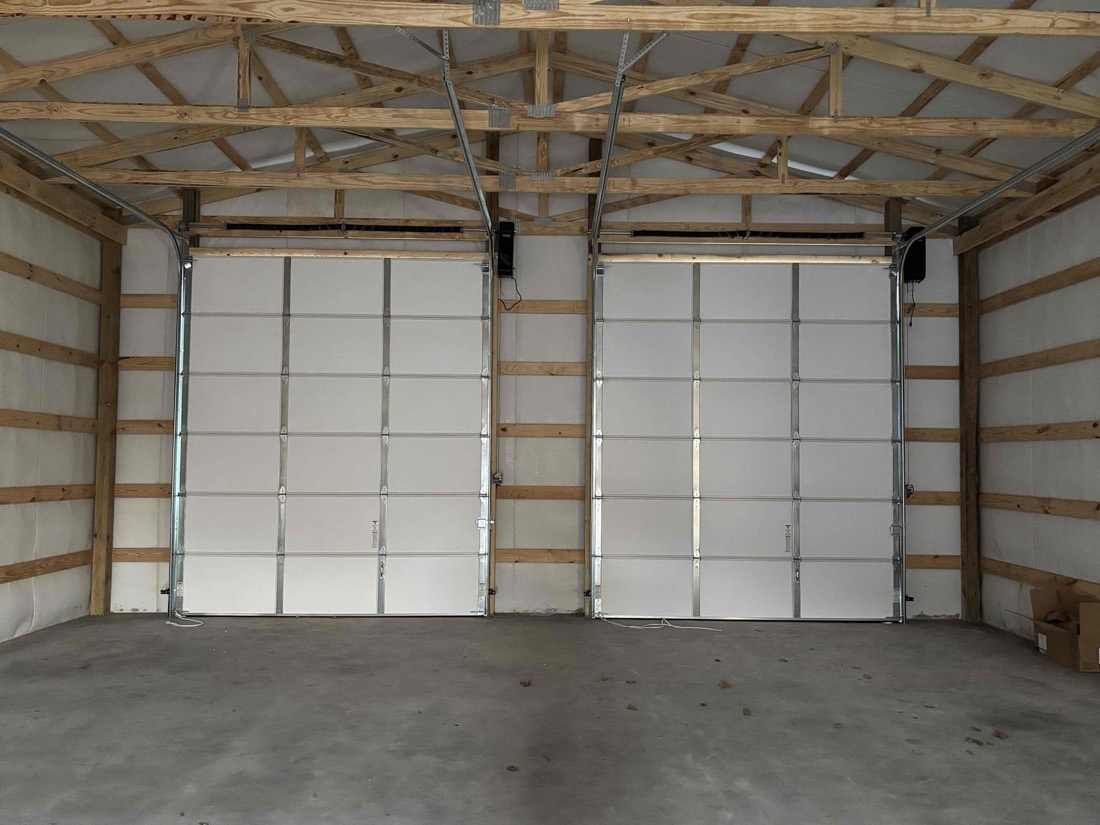 Interior view of two white garage door panels with metal framing