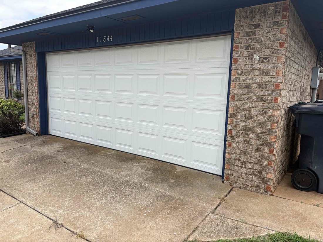 White garage door installed on brick home in Yukon