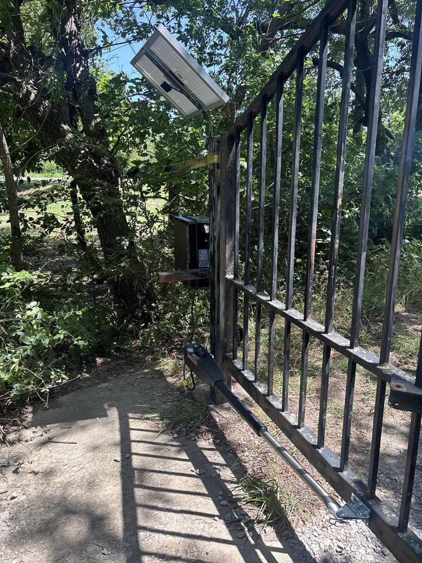 Solar panel and control system installed on residential metal gate structure.