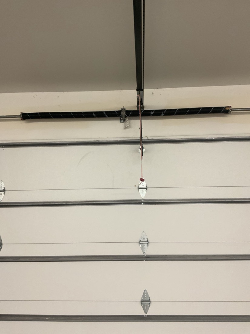 New garage door spring installed on horizontal garage door track system.
