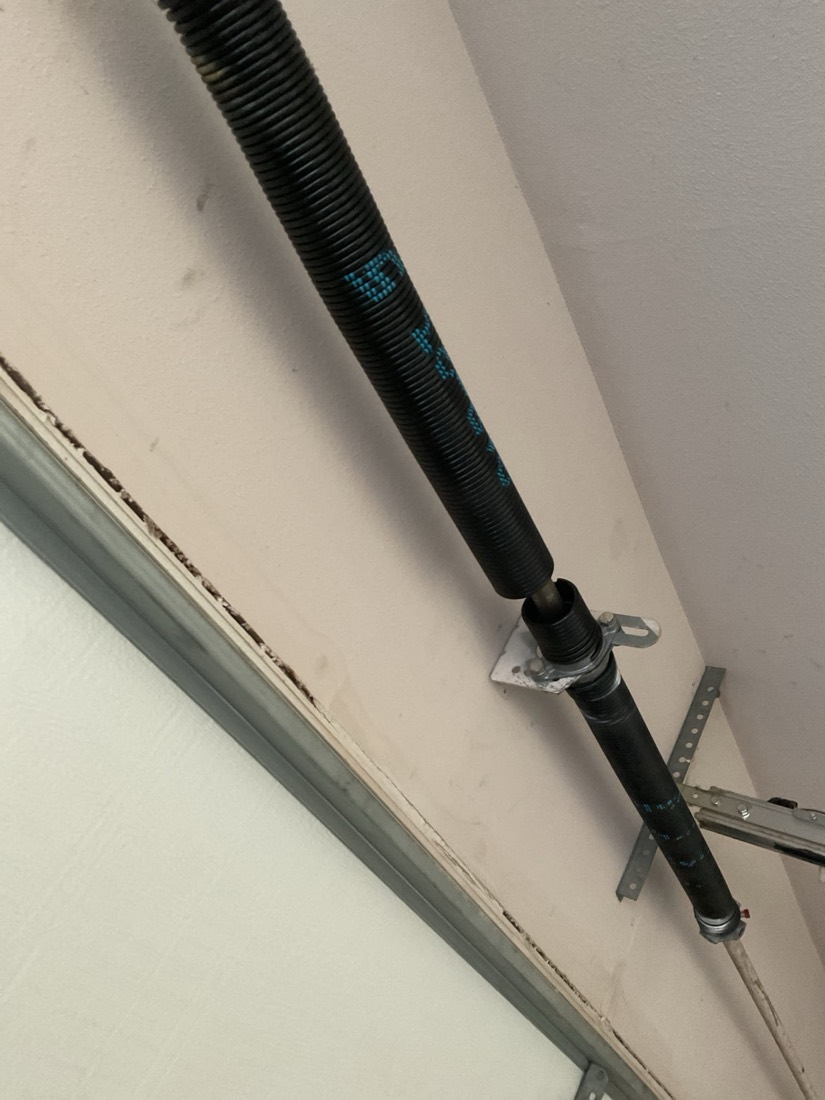 Replaced garage door torsion spring with mounting hardware