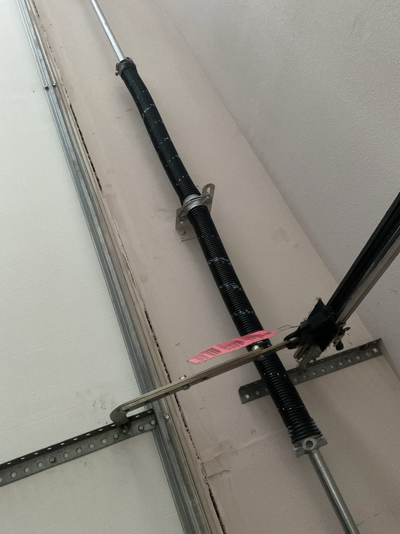 New garage door spring with mounting brackets and safety cable