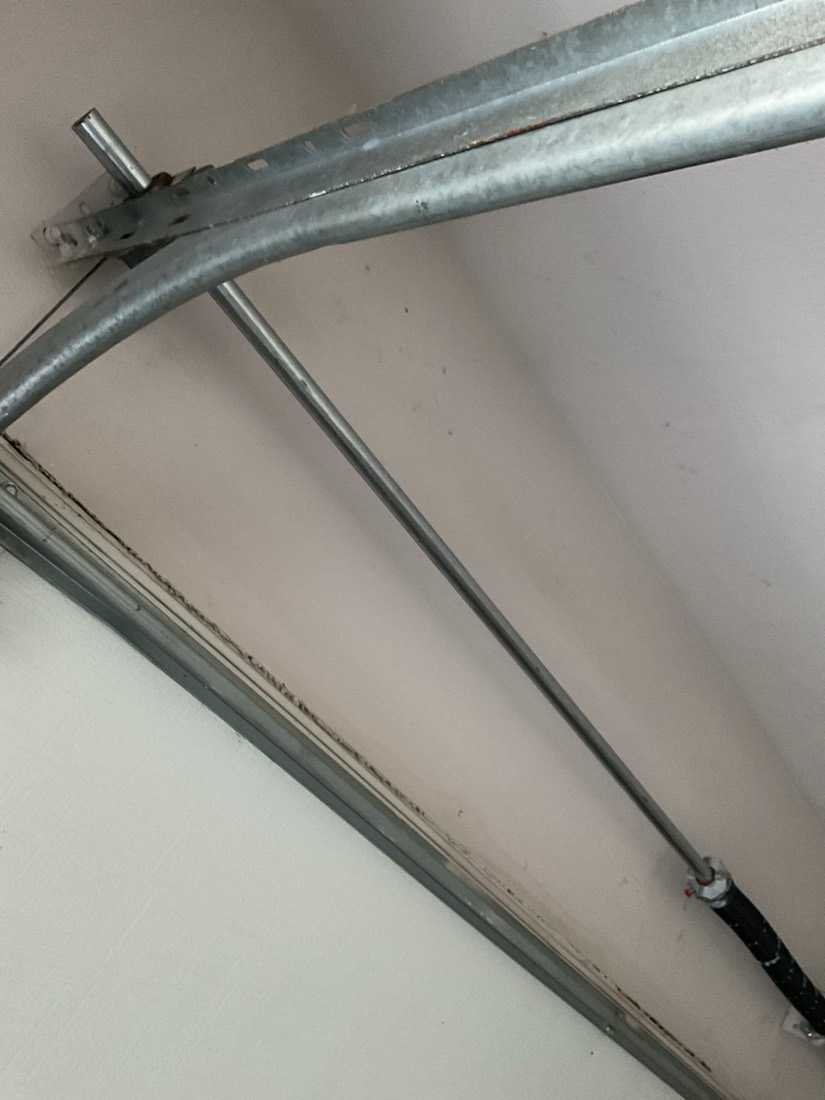 Installed torsion spring and cable assembly on garage door