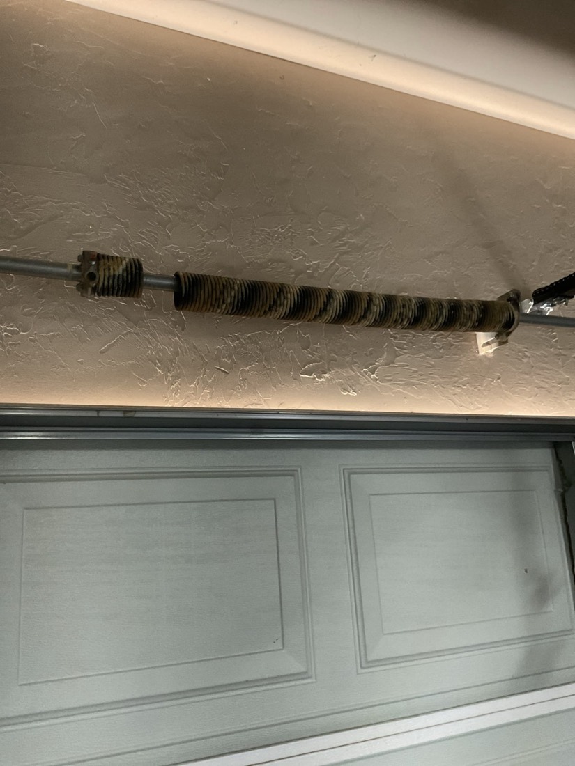 Replacement torsion spring on garage door.