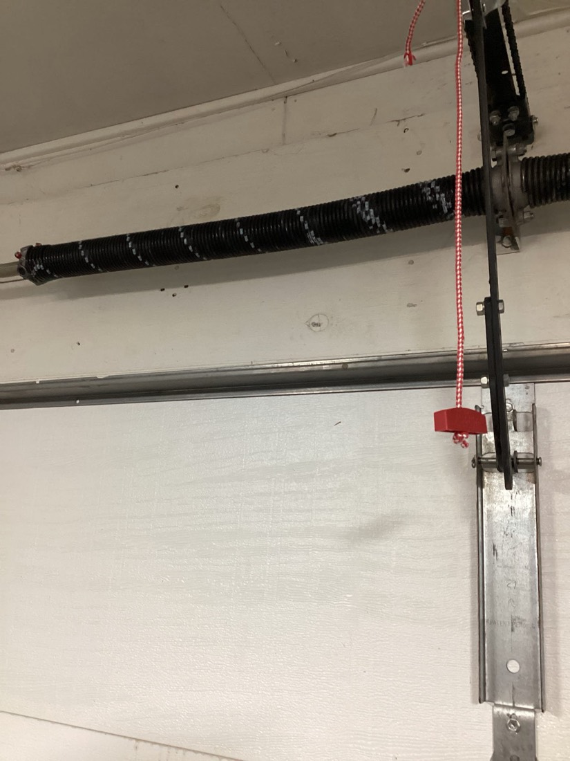 Installed torsion spring and cable system on garage door.