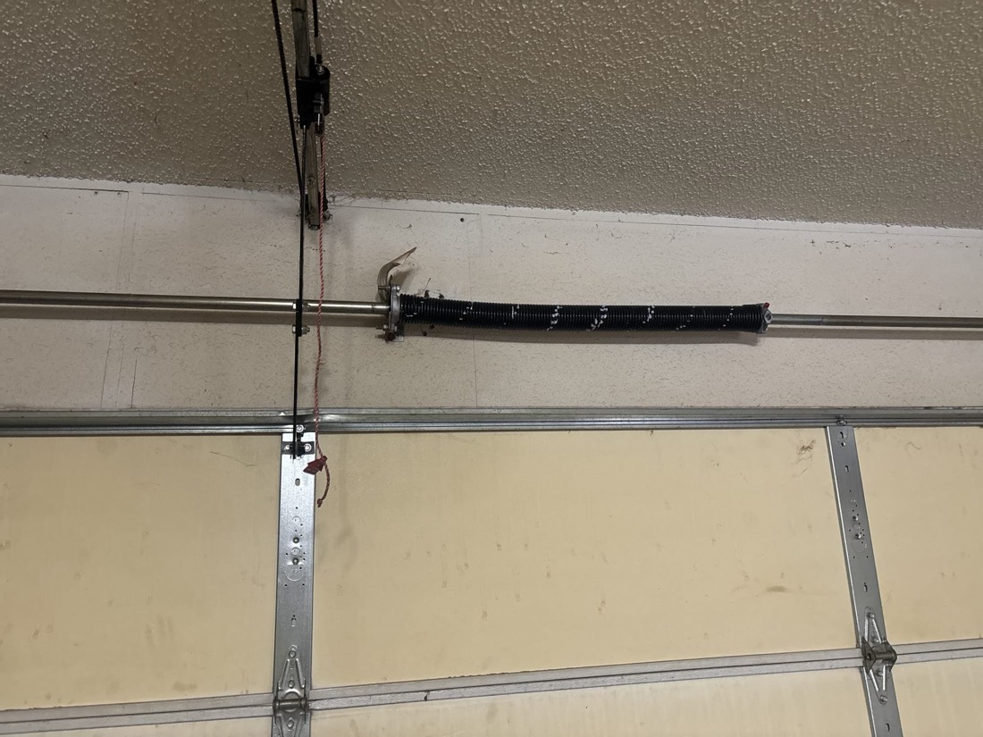 Torsion spring and bracket installed on garage door