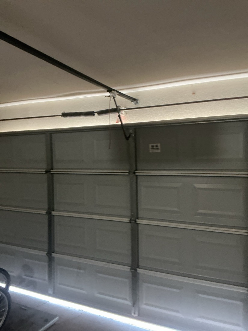 Gray modern garage door with complete spring system installed.