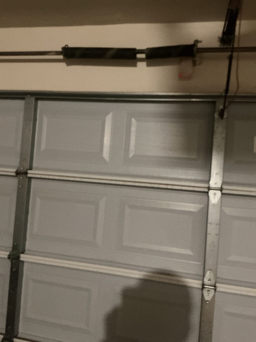 Garage door with new spring and cable hardware installed