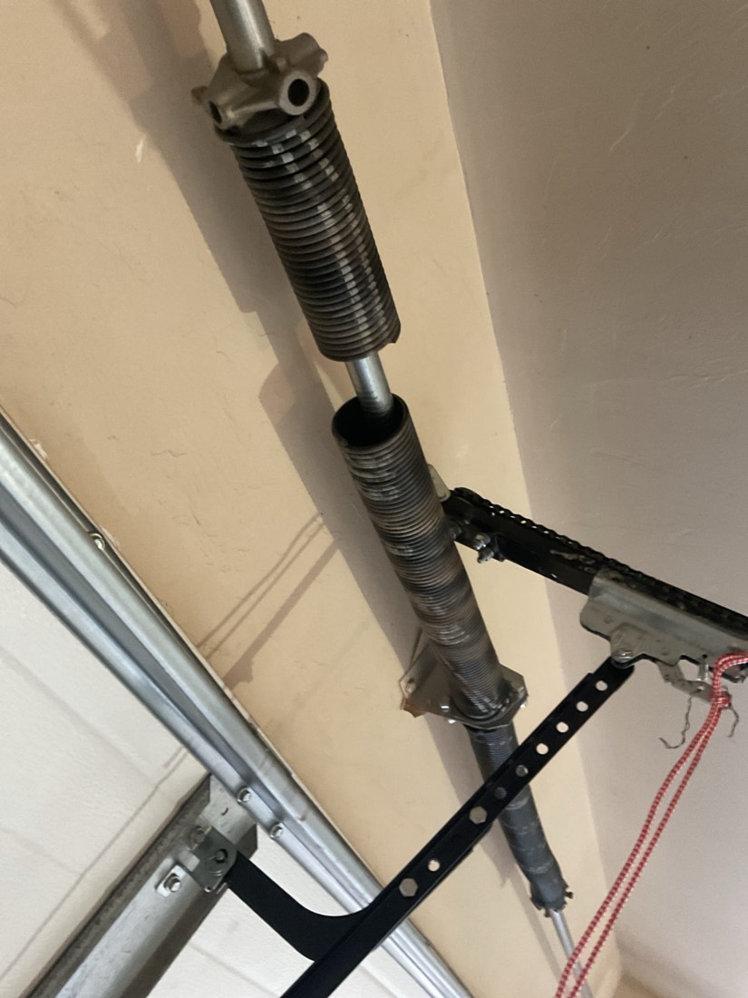 Installed garage door spring and hardware on garage door frame