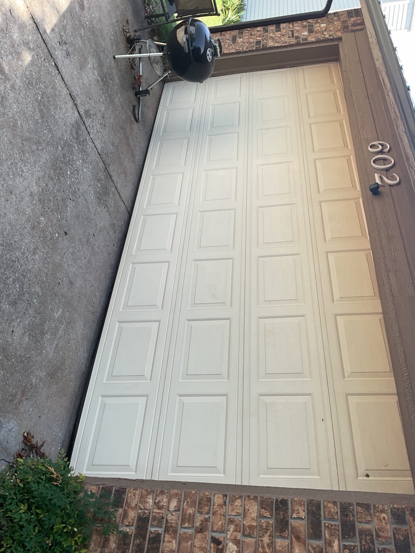 Finished white sectional garage door after installation