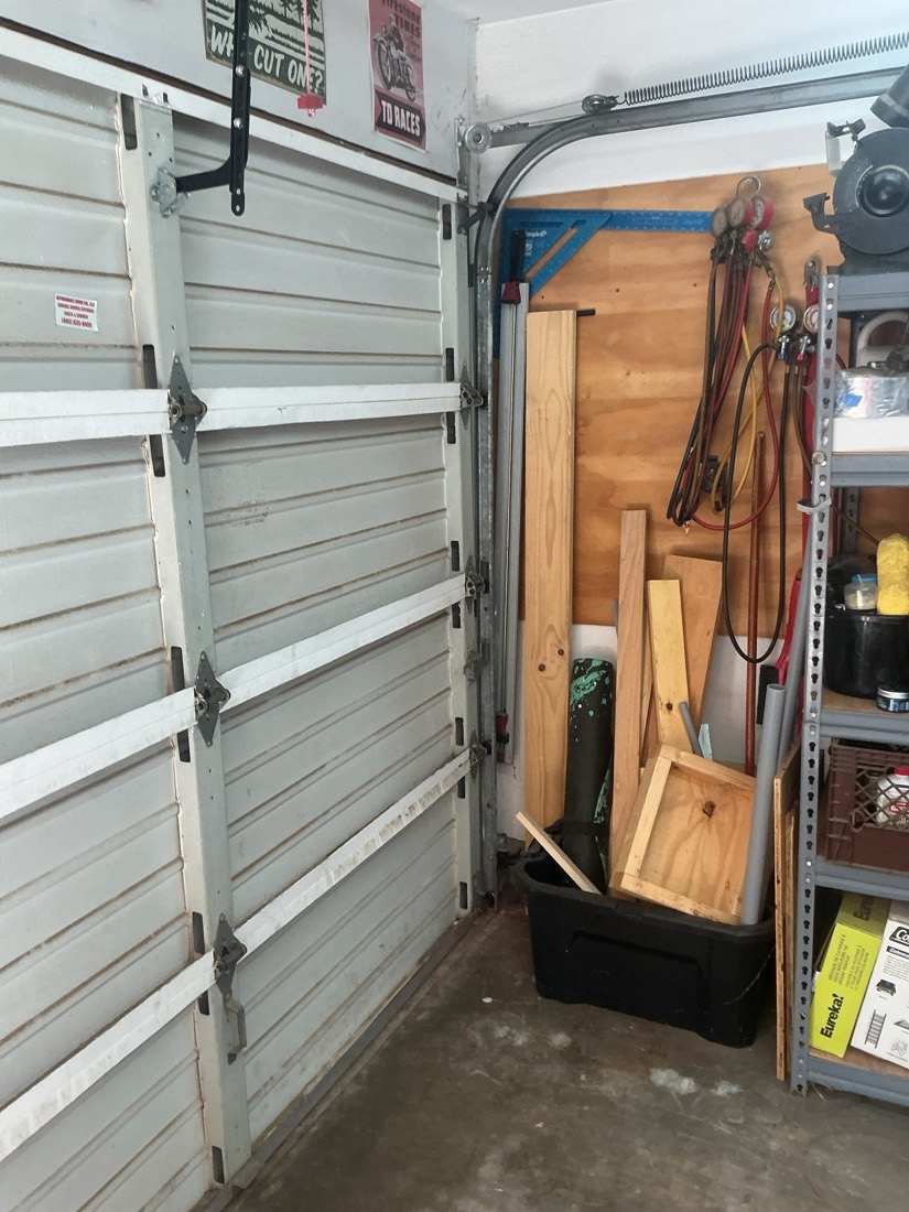 Garage door spring mechanism and hardware repair installation.