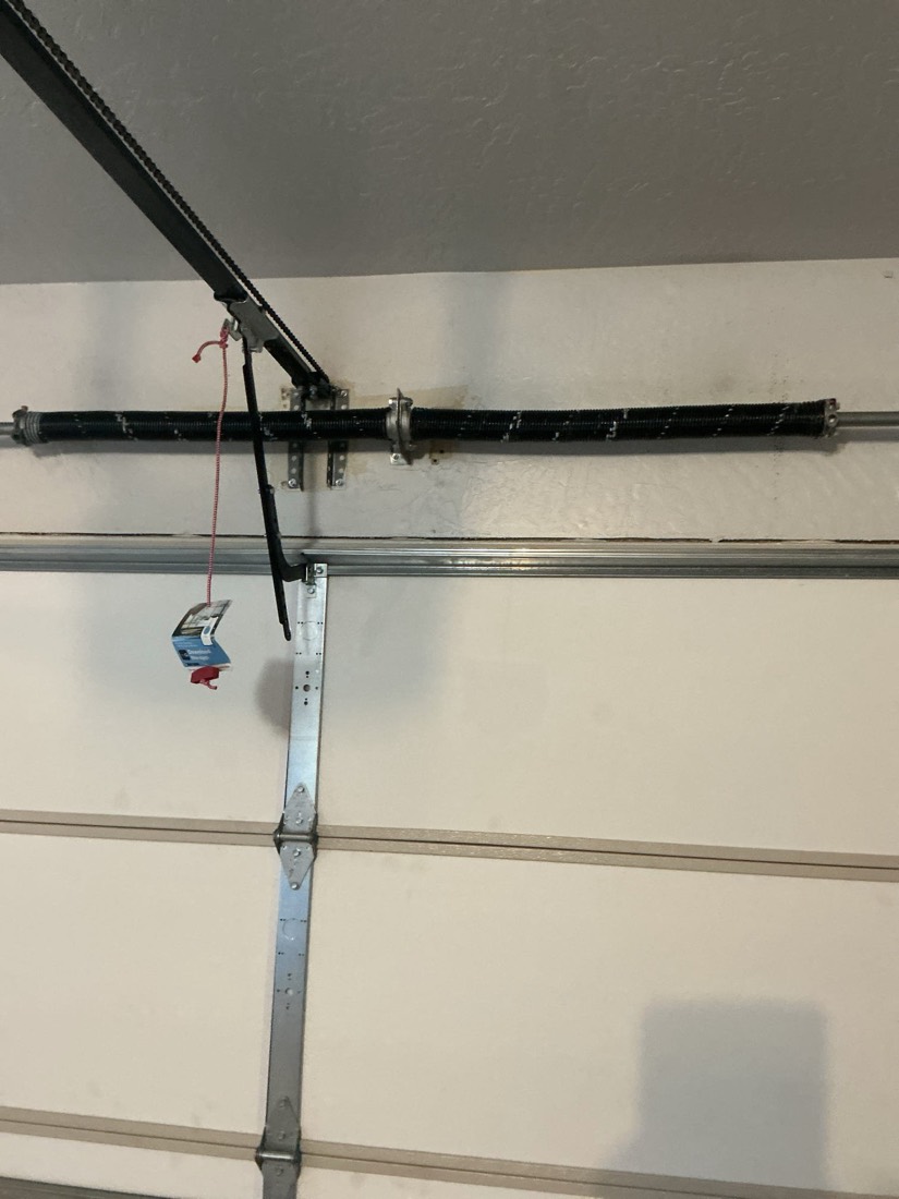 New torsion spring assembly installed on garage door