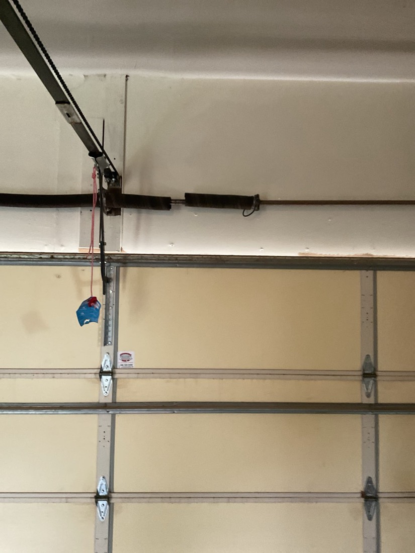 Spring and pulley assembly on garage door