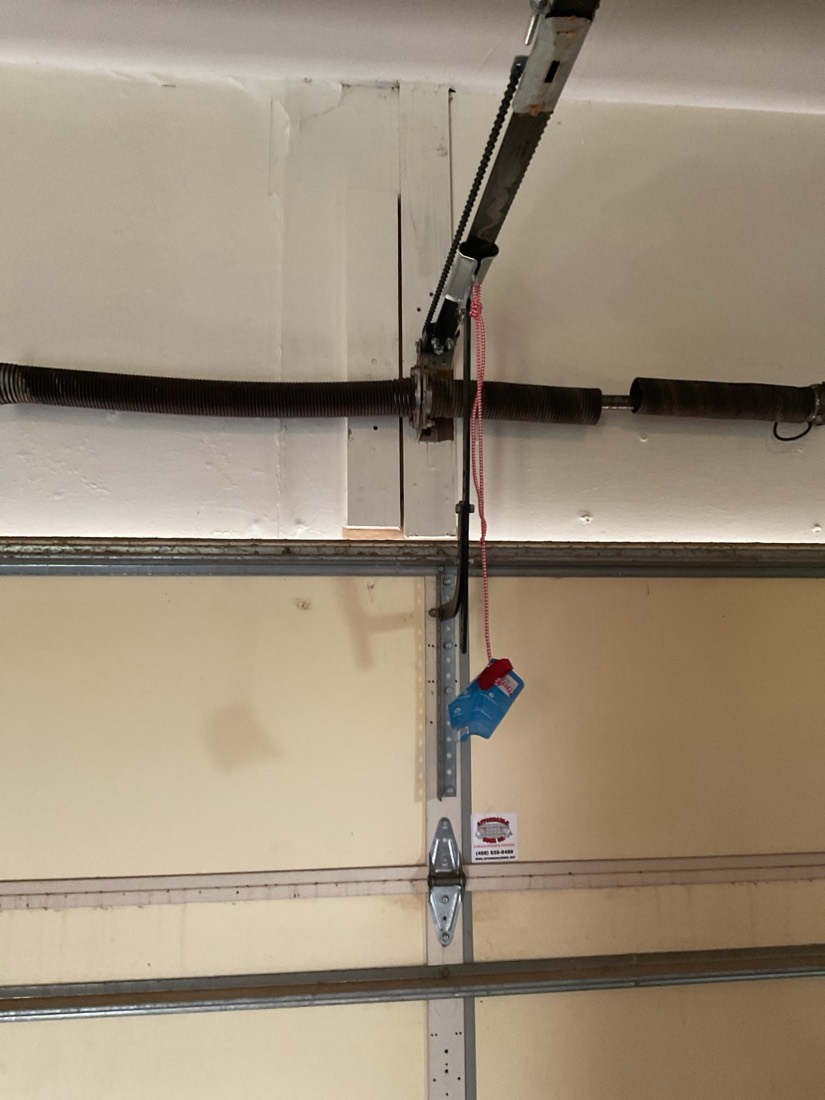 Installed torsion spring and cable system on garage door