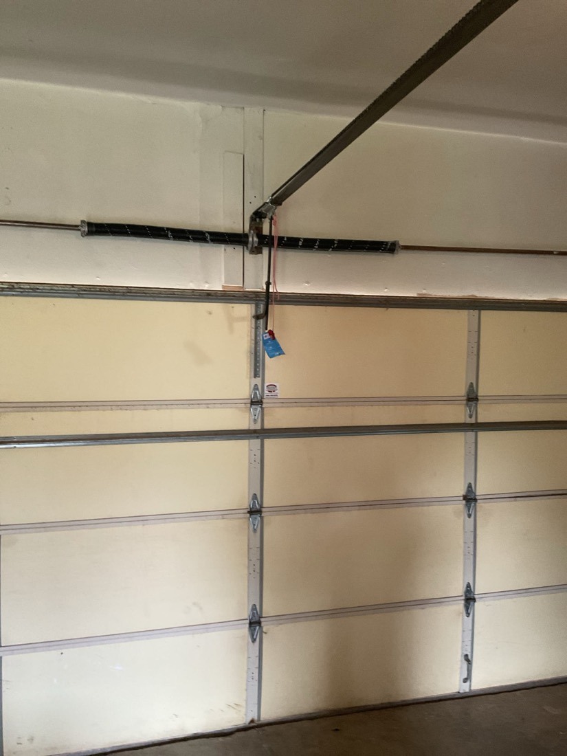 Torsion spring and pulley system on garage door