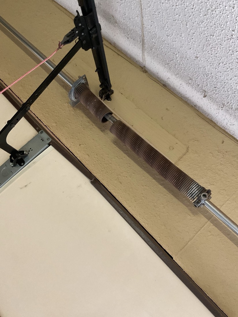 Close-up of installed garage door spring and mounting bracket