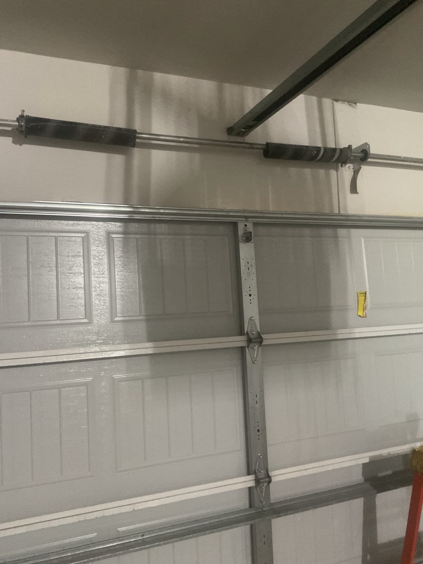 Newly installed garage door spring system with balanced hardware